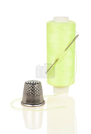 Photo for Coil with yellow thread needle and thimble isolated on white background - Royalty Free Image