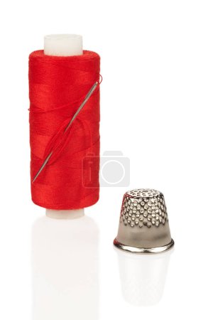 Photo for Coil with red thread needle and thimble isolated on white background - Royalty Free Image