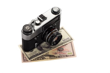 Photo for Old vintage camera with dollars isolated on white background. - Royalty Free Image