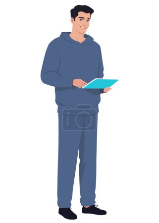 Photo for A man stands in casual clothes holding a tablet in his hands - Royalty Free Image