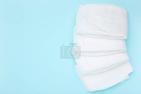 Photo for Baby diapers on blue background - Royalty Free Image