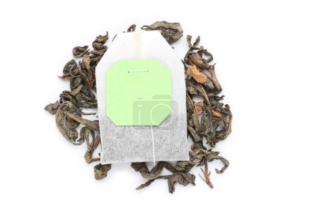 Photo for Tea bag with scattered tea isolated on white background - Royalty Free Image