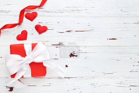 Photo for Gift box with hearts and ribbon on wooden background - Royalty Free Image