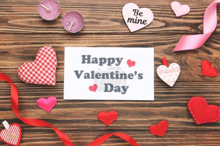 Photo for Text Happy Valentines Day with hearts and ribbons on brown wooden background - Royalty Free Image