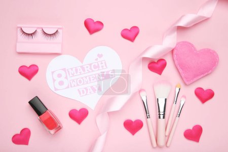Photo for Card in shape of heart with text 8 March Women's Day, hearts and ribbon, nail polish, set makeup brushes and eyelashes on pink background - Royalty Free Image
