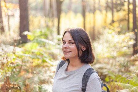 Photo for Portrait of a beautiful young woman with backpack looking at cam - Royalty Free Image
