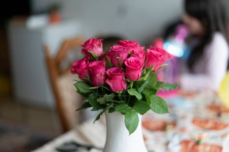 Beautiful bouquet of pink roses in vase on the table