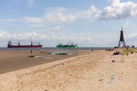 Cargo ship on the North Sea beach in Holland, Netherlands.