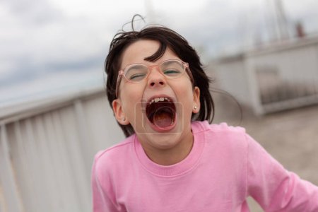 Foto de Retrato de una joven loca con gafas y camiseta rosa - Imagen libre de derechos