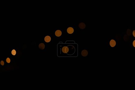 Blurred bokeh circles on a dark background out of focus area