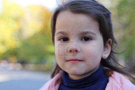 Autumn's Darling: Little Girl Radiates Beauty in Pink and Blue