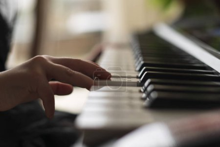 Little children's fingers play the piano. Soft focus photo