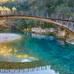 Aerial view of  voidomatis river with the clear waters and the famous bridge in epirus Greece.