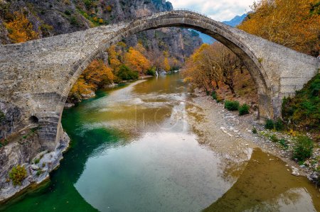 Aerial view of the stone bridge of Konitsa over Aoos river with automn colors , in Zagori, Epirus, Greece.