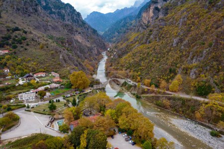 Photo for Aerial view of the stone bridge of Konitsa over Aoos river with automn colors , in Zagori, Epirus, Greece. - Royalty Free Image