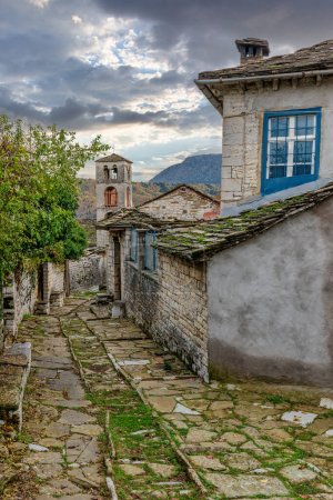 Photo for The picturesque village of Dilofo during fall season with its architectural traditional old stone  buildings located on Tymfi mount, Zagori, Epirus, Greece, Europe - Royalty Free Image