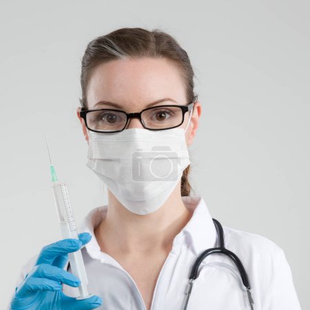 Photo for Female doctor or nurse with syringe respectively venipuncture - Royalty Free Image