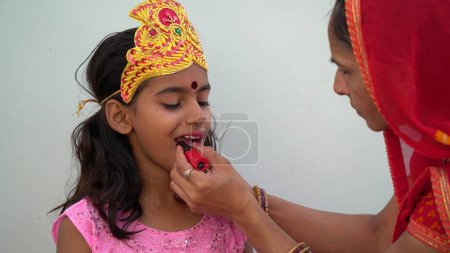 Photo for A Girl Wearing Tradition Dress On Festive Season Navratri. Portrait of pretty little Indian girl wearing traditional dress. Preparing makeup for dandiya festival - Royalty Free Image