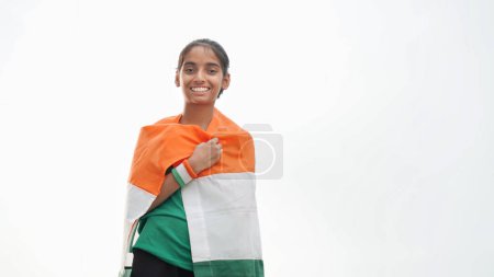Photo for Happy cute girl wrapped indian flag around her body celebrating Independence day or Republic day. - Royalty Free Image
