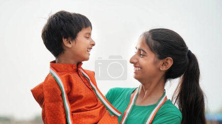 Photo for Indian brother and sister celebrating Independence or Republic day, Cute little Indian child smiling - Royalty Free Image