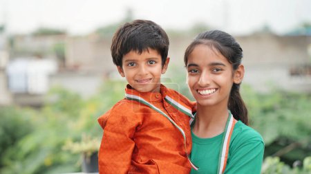 Photo for Indian brother and sister celebrating Independence or Republic day, Cute little Indian child smiling - Royalty Free Image