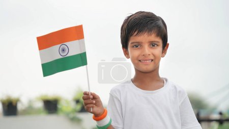 Photo for Portrait of a little cute boy with tricolour indian flag, boy to show national pride. Independence day - Royalty Free Image