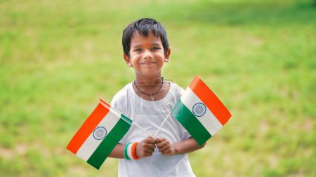 Photo for Cute little boy with Indian National Tricolour Flag, Isolated over nature background. Suitable for Independence Day or Republic Day concept - Royalty Free Image