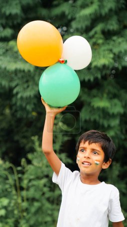 Photo for Cute little boy with Indian Flags painted on cheeks  holding balloons - Royalty Free Image