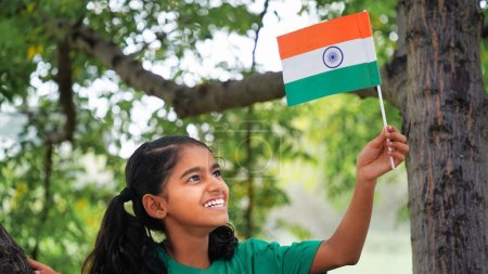 Photo for Indian girl celebrating indian independence day. gorl with flag in the park - Royalty Free Image