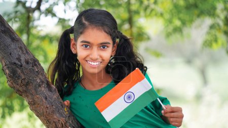 Photo for Indian girl celebrating indian independence day. gorl with flag in the park - Royalty Free Image
