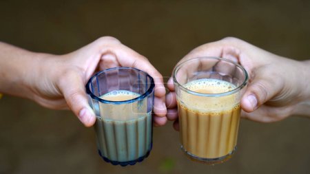 Photo for Indian masala tea or chai in traditional glass, wooden background. cafe, retro, restaurant, hotel concepts. The early morning cutting chai - Royalty Free Image