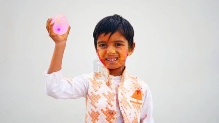Téléchargez les photos : Poudre de couleur holi soufflant de la main pendant la célébration du festival Holi - Concept de jeunes enfants s'amusant en jouant Holi pendant la fête - en image libre de droit