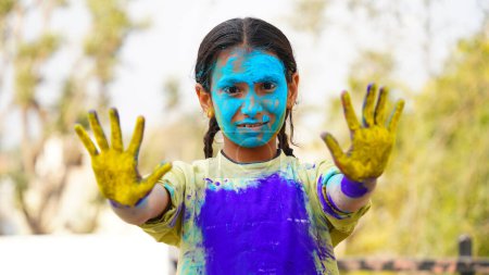 Photo for Happy Cute Smiling little Indian kids showing their colourful hands or palm printing or playing holi festival with colours - Royalty Free Image