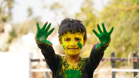 Photo for Happy Cute Smiling little Indian kids showing their colourful hands or palm printing or playing holi festival with colours - Royalty Free Image