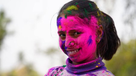 Photo for Happy Indian kids playing colours, smiling with colors on face or asian children celebrating Holi. Concept for Indian festival Holi. Bright kids smeared in colored powder - Royalty Free Image