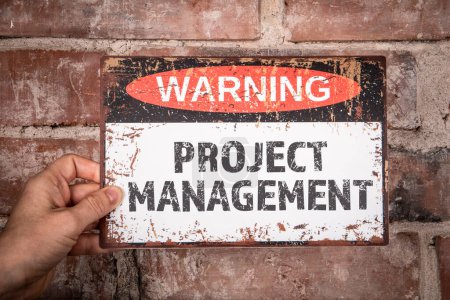 Photo for Project Management Concept. Warning sign with text in the hands of a woman. - Royalty Free Image