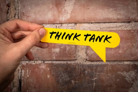 Think tank. Yellow speech bubble with text on a red brick background.