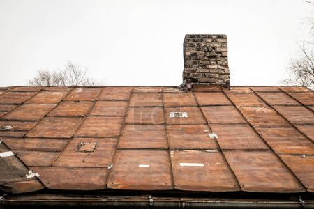 Photo for Old rusty metal roof with patches. Repair and renovation. - Royalty Free Image