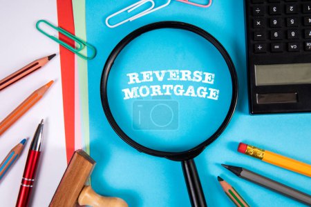 Reverse Mortgage. Magnifying glass and stationery on the office table.