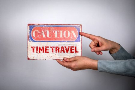 Photo for Time Travel Concept. Caution sign with text in woman hand on white background. - Royalty Free Image