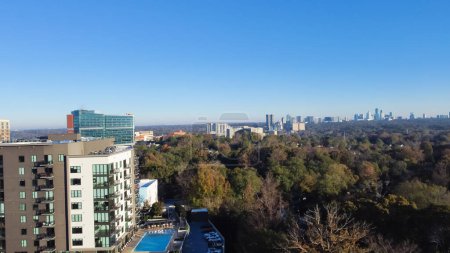 Photo for Aerial view complex of apartment buildings, hotel and cooperate towers with swimming pool in Brookwood Hills neighborhood area surrounded by colorful fall foliage autumn leaves. Sunny clear blue sky - Royalty Free Image