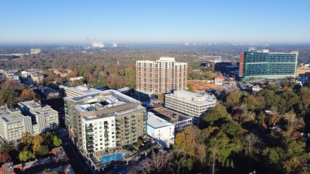 Photo for Aerial view complex of apartment buildings, hotel and cooperate towers with swimming pool in Brookwood Hills neighborhood area surrounded by colorful fall foliage autumn leaves. Sunny clear blue sky - Royalty Free Image