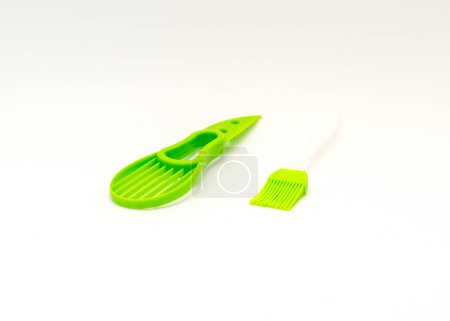 Photo for Cooking oil brush and all-in-one avocado slicer knife and non-slip silicone handle isolated on white background. Dishwasher safe cutter and pitter tool for avocado - Royalty Free Image