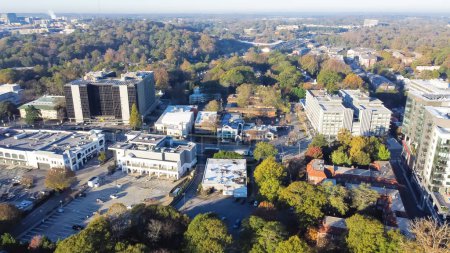 Photo for Aerial view office buildings in Brookwood Hills neighborhood near the busy I-75 and I-85 split, midtown Atlanta, Georgia, US. Modern high-rise tower surrounded by colorful fall foliage autumn leaves - Royalty Free Image
