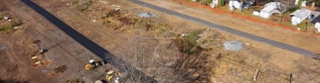 Foto de Panorama aerial heavy machines foundation, earthmoving works at mobile home park construction site near row of completed manufactured trailer houses in Rochester. Upstate New York housing community - Imagen libre de derechos