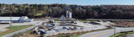 Photo for Panorama aerial ready-mixed concrete batching plant with cement silo, weigh hopper, conveyors, screw feeder and aggregates granular gravel, crushed stone. Industrial factory near highway Georgia, USA - Royalty Free Image