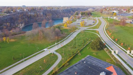 Photo for Pathway along Niagara Falls between New York, USA Ontario, Canada border looking over Canada side with riverside hotels, casinos, restaurantscolorful autumn leaves. Aerial view scenic destination - Royalty Free Image