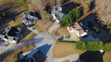 Aerial top view cul-de-sac passage closed end in residential neighborhood with low density housing designation, no fence and well-trimmed yards suburbs Atlanta, Georgia, USA. Aerial upscale homes