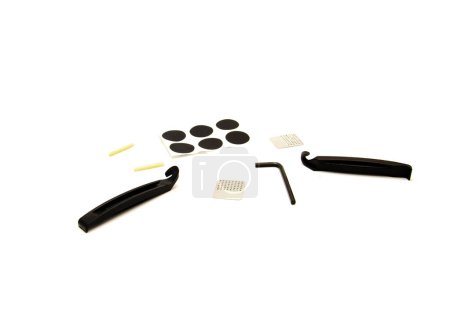 Photo for Tire levers and assorted bike tire repair patch kits metal scuffer, round patches, flat hex wrench repair cycling maintenance portable set isolated on white. Bicycle gear accessories clipping path - Royalty Free Image