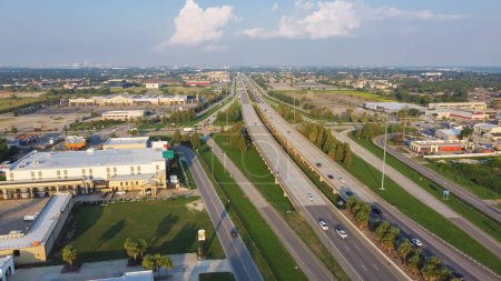 Photo for Aerial view busy Interstate Highway 10 (I-10) intersection with Crowder boulevard with gas station, restaurant, hotel buildings, grocery stores near downtown Little Woods New Orleans USA. Aerial view - Royalty Free Image